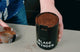 Blade grinder filled with unevenly ground coffee, showing inconsistent grind size