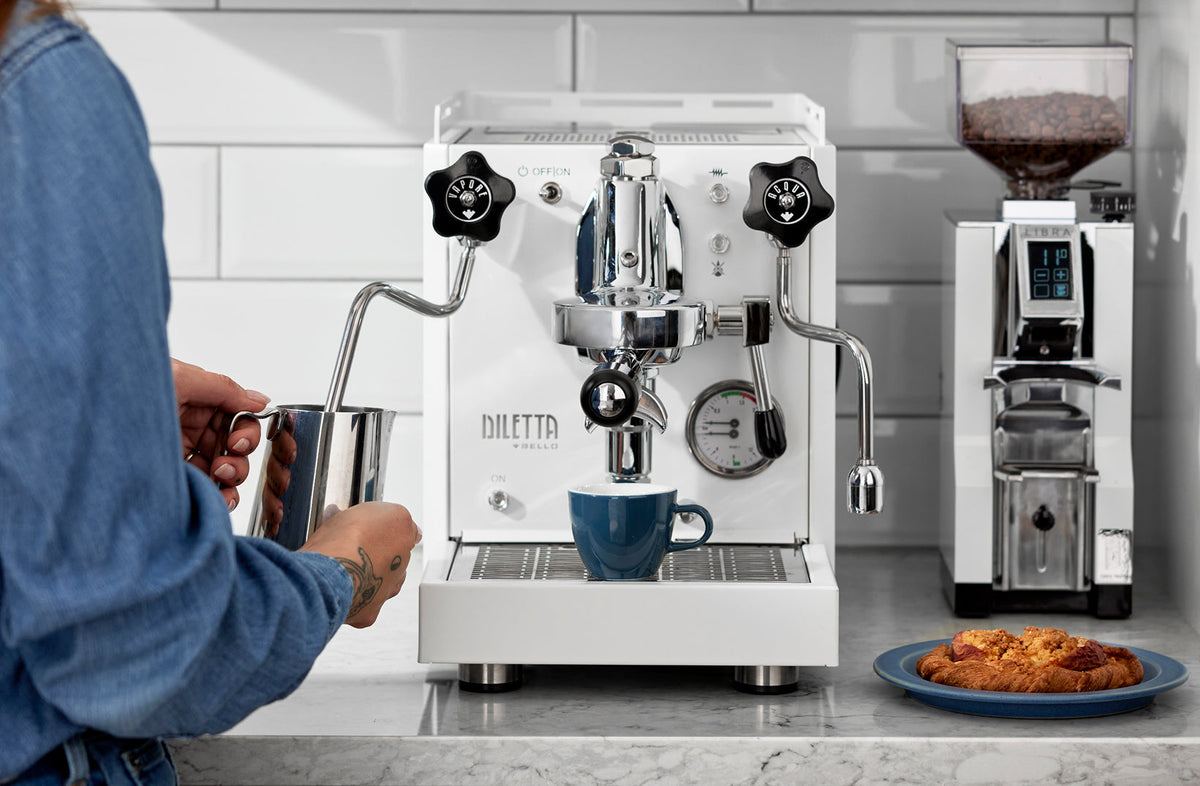 Diletta Bello espresso machine brewing a shot beside a Eureka Libra grinder - Seattle Coffee Gear