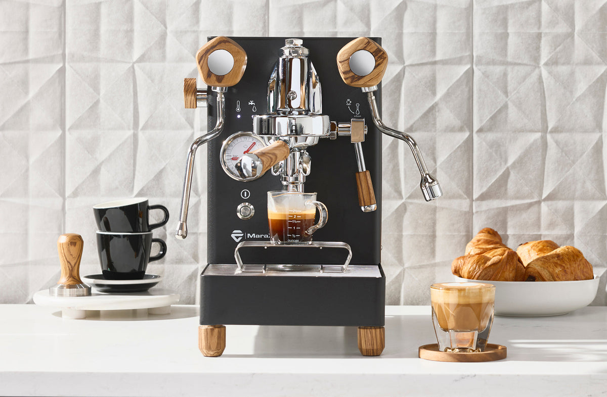 LELIT Mara X3 espresso machine in black with wood accents pulling a shot on a counter - Seattle Coffee Gear