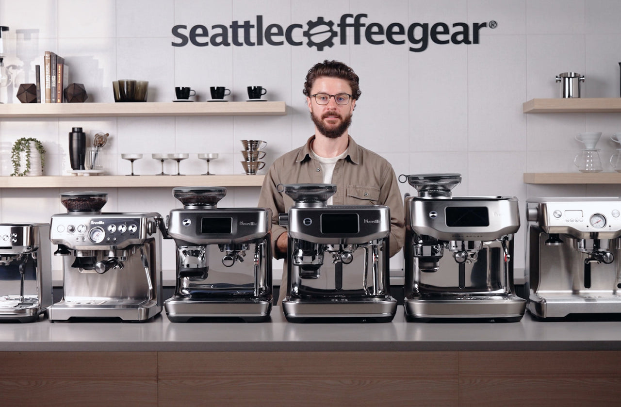 Six Breville espresso machines lined up on a Seattle Coffee Gear counter