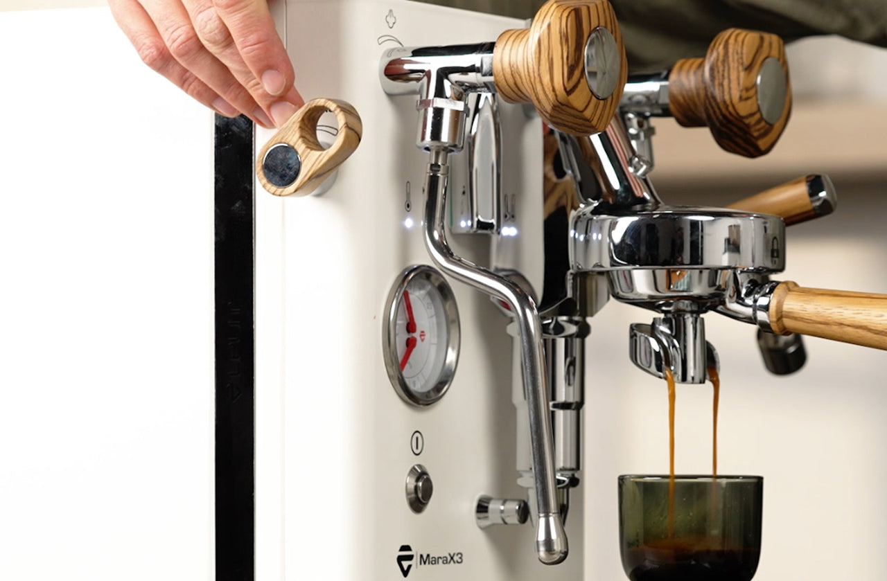 LELIT Mara X3 pulling espresso while a hand adjusts the Pagaia flow profiling paddle