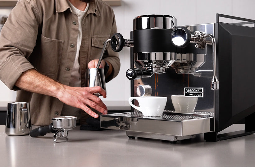 Prosumer espresso machine pulling a shot on a modern kitchen counter