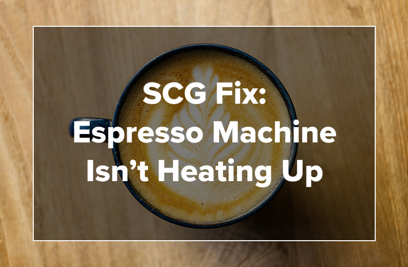 A latte in a dark mug with text reading SCG Fix: Espresso Machine Isn't Heating Up