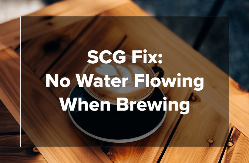 An overhead shot of a latte in a dark cup on a wooden tray with text reading SCG Fix: No Water Flowing When Brewing