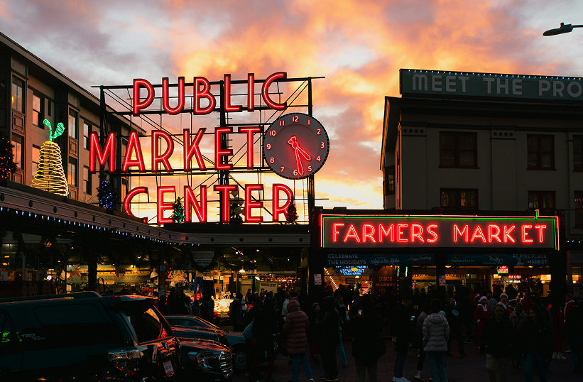 Pike Place Market neon sign glowing at sunset in downtown Seattle - Seattle Coffee Gear